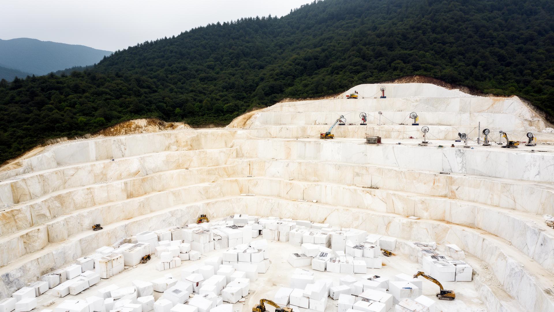 The Daphne White quarry — stepped open-pit terraces above the cut blocks at the pit floor.