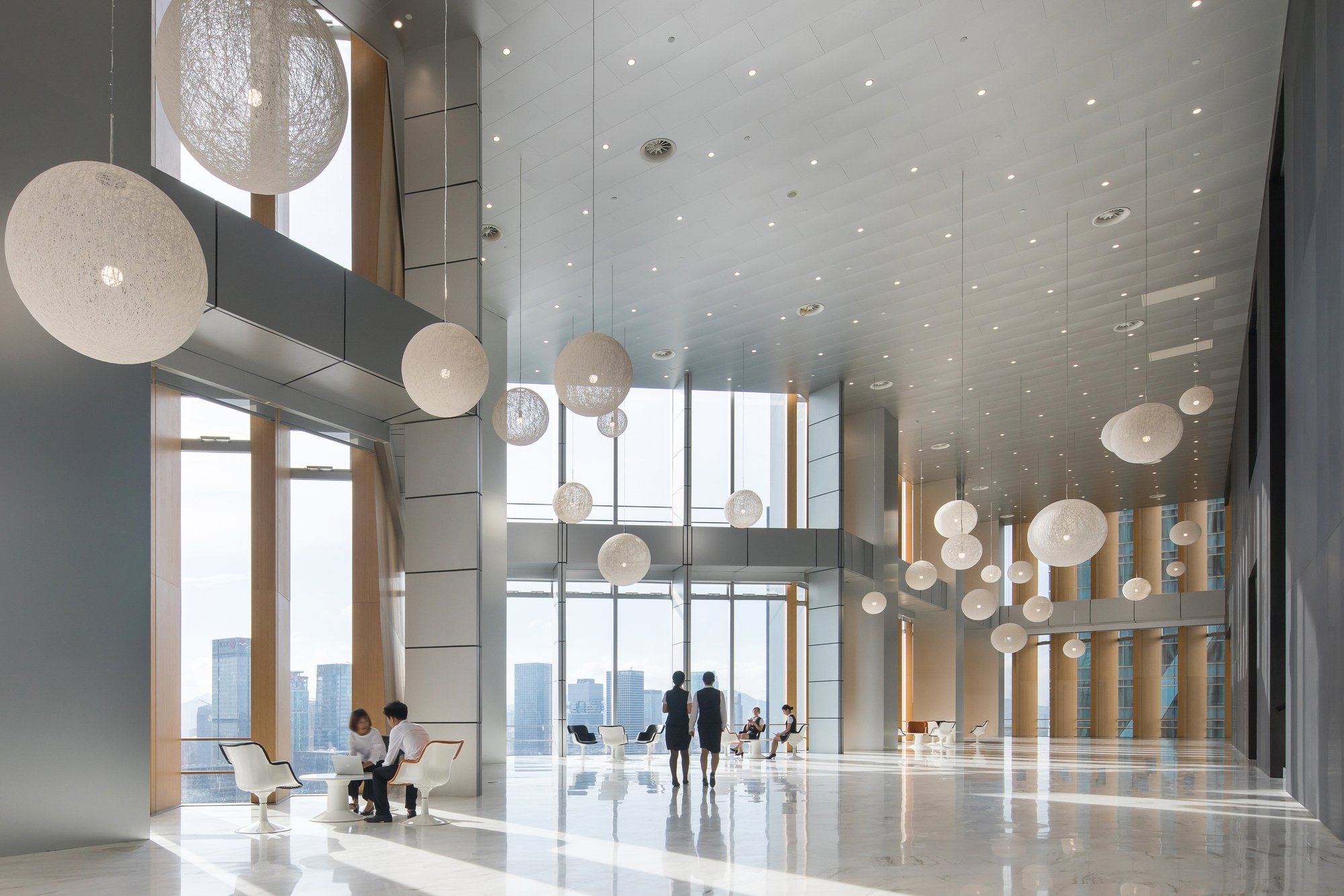 Pleated curtain wall — opaque panels block direct sun, glazed panels capture diffuse light. Photo © Chao Zhang.
